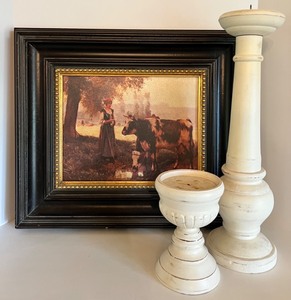 lot 62 image: Old World Style Art - Woman with Cow and 2 Wood Candle Pillars