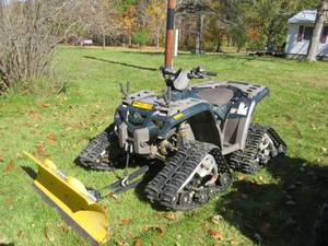 lot 1 image: 2004 Bombardier Outlander 400 ATV with Tracks and Extended Snowplow and Set of Tires
