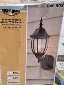 lot 1542 image: Hampton Bay Black Powder Coated Motion Sensing Wall Lantern (in original box)