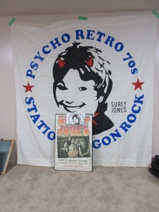 lot 157 image: SURLEY JONES ACTUAL STAGE BANNER, POSTER AND T-SHIRT