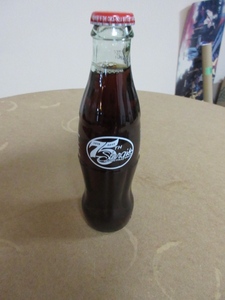 lot 169 image: STURGIS 75 YEAR ANNIVERSARY COKE BOTTLE