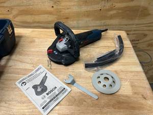 lot 24 image: BOSCH 12.5 Amp Corded 5 in. Concrete Surfacing Grinder with Dedicated Dust Collection Shroud (retails for $459)