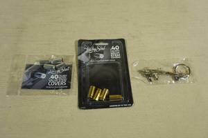 lot 103 image: 2 Packs Lucky Shot 40 Cal Valve Stem Cover with Keychain