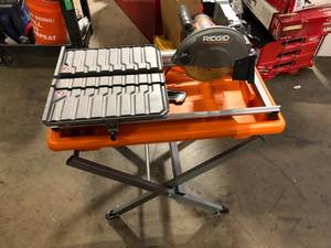 lot 26 image: RIDGID 9 Amp 7 in. Blade Corded Wet Tile Saw with Stand   Customer Returns See Pictures