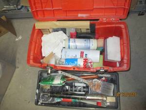 Toolbox filled with assorted hardware and painting supplies