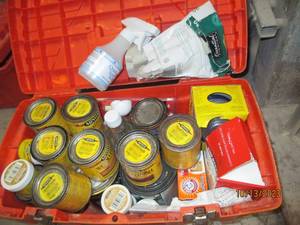 Toolbox filled with stain, wood putty and more