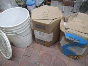 1 plastic bucket 12 full of Gravel. 2 boxes of formula #1 sweeping compund 50 LB each.