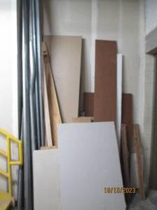 Assorted Materials. Drywall, metal pipes, plywood, composite wood, and wood planks.