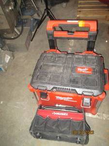 Milwaukee tool box with handle on wheels and a Husky tool tote