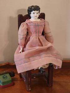 lot 62 image: Awesome Antique Porcelain Doll With Chair and Toy Telephone