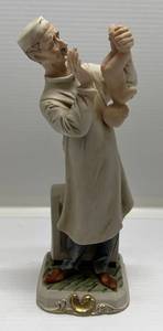 lot 40 image: 1950s  Porcelain Doctor And Baby Statue 10 12 Tall