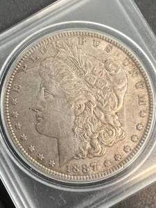 lot 21 image: 1887 US MORGAN SILVER DOLLAR IN CASE