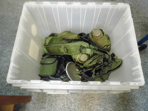 lot 323 image: Covered tote filled with military gear and clothing