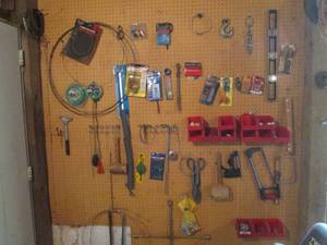 lot 74 image: Content of Shop wall including grommet kits, hack saws, tin snips,  4-way tire iron, parts organizer Bins, hose clamps, scraper and so much more