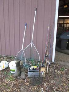 lot 476 image: Assortment of fishing rods and reels, large nets, wading boots,  Styrofoam coolers and other fishing gear.