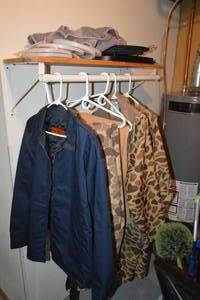 lot 233 image: Assorted Pants and Jackets  Shelf Contents