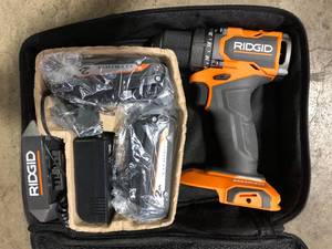 lot 6 image: RIDGID 18V SubCompact Brushless Cordless 12 in. DrillDriver Kit with (2) 2.0 Ah Batteries, Charger, and Tool Bag   Customer Returns See Pictures
