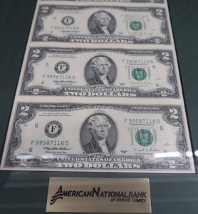 lot 15 image: FRAMED UNCUT SHEET OF 2 DOLLAR BILLS