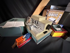 lot 471 image: Vintage Argus 500 Slide Projector, Slide Converter, Projection Screen and Boxes of Slides