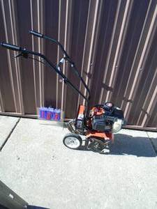 lot 102 image: Earthquake mini roto tiller with factory cordless electric start. Does not have battery or charger. Tested & works. As shown.