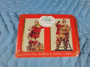 lot 153 image: 1994 Coca-Cola double pack playing cards in tin and 1998-1989 mini Coca-Cola ornaments.