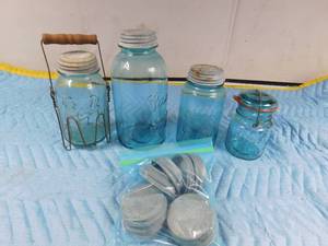 lot 149 image: 4 Vintage blue glass Ball jars and lots of vintage metal lids