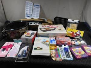 lot 288 image: Tote of crock pot, serving pans, new mini waffle maker, vacuum packs, pell remover, new ladder toss game. vegetable slicer. amd craft supplies