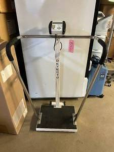 lot 15 image: Detecto 750 Digital Waist High Bariatric Scale With sturdy handrails for weighing unsteady patients safely - 600 pound capacity x 0.2 pound resolution - Good Working Condition - Could Use&nbsp6 AA batteries (not included)&nbspSoon