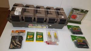 lot 596 image: 5-can ammo crate mini. Remington dehumidifier. Rem Oil. Gun sock.