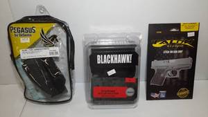 lot 1352 image: (3) Firearm Accessories Pegasus by DeSantis Slim Tuk Holster S&W Blackhawk Grip Break Nylon Holster Talon Grips