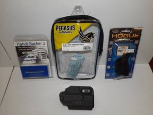 lot 1392 image: (3) Firearm Accessories Pegasus Holster, Slim Tuk, Ruger Security 9 Comp Hogue Handall Beavertail Grip Sleeve Handi-Racker 2
