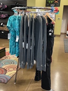 lot 1423 image: (10) Girls with Guns Clothing (3) Teal Shirts (1) XL Black Carbine Pants (6) Tom Boy Cowl Neck Hoodies