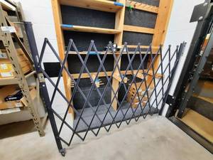 lot 1637 image: Global Folding Security Gate extends to 76 inches