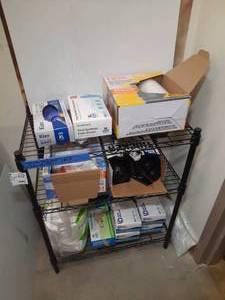 lot 1808 image: Trash bags, vinyl gloves, wipes and a black wire  rack, 24 W X 14 D X 30 H