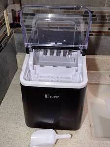 lot 1823 image: Ulit Ice Maker, Model IM1226-B1 and ice scoop.