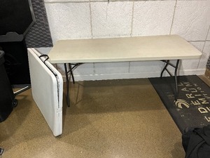 lot 1846 image: (2) White Folding Tables with easy-to-carry handle. Measures 72 W X 30 D X 29 H.