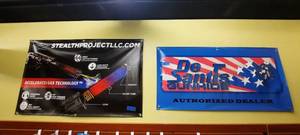 lot 1878 image: (2) Vinyl Banners Stealth Project measures 48 x 30 DeSantis measures 48 x 24.