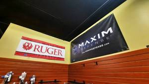 lot 1879 image: (2) Vinyl Banners Ruger 59 x 23 Maxim 72 x 36.
