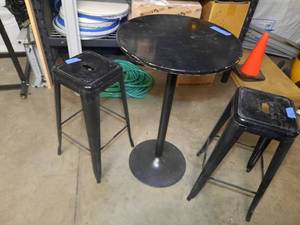 lot 1710 image: Black Metal Cafe Table and 2 metal black stools. Table measures 24 dia. x 40 H Stool measures 12 x 12 x 30 H