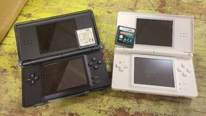 lot 35 image: 2 Nintendo DS handheld gaming devices with games
