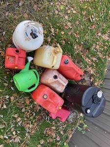 Lot of plastic gas cans and a LP tank