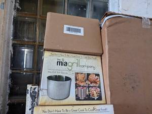 Corner value lot including several Mia Grill beer can style infusion cookers, new ottomans, and more
