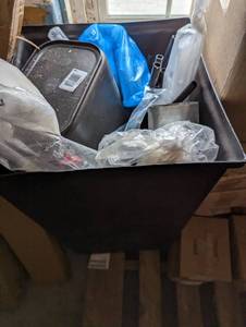 Commercial grade trash bin filled with new and open box commercial supplies