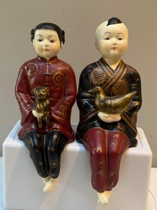 lot 46 image: China Sitters Ceramic Figurines, Boy Girl, Holding a Bird & a Cat