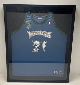 lot 1 image: 2004 MVP Kevin Garnett Signed Jersey With Foil Seal (BAJ 28082) 66121 Framed Behind Glass  33 x 40 12