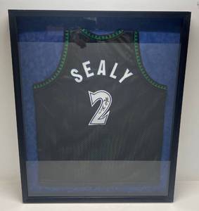 lot 2 image: Malik Sealy Signed Jersey Framed Behind Glass 32 x 38 12