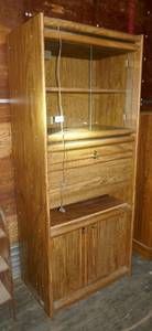 lot 8 image: Cabinet with glass doors on top, wood on bottom, roll top middle