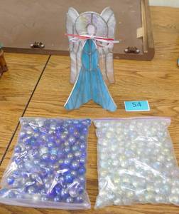 lot 54 image: Stained glass angel and 2 bags of marbles