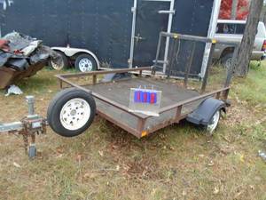 lot 110 image: 2 Wheel trailer approx 60 x 80. Has mesh under plywood. Bill of sale only. Has lifetime sticker. THIS ITEM HAS A RESERVE.
