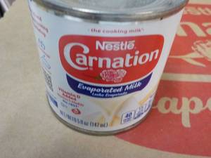 lot 86 image: 24 ct 5 oz Cans Nestles Carnation Evaporated Milk - best date 08312023